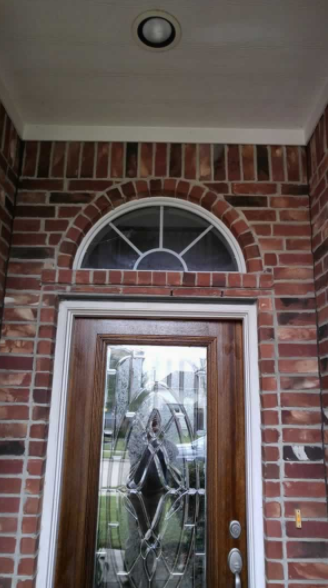 Elegant modern entry door with decorative glass panels on an upscale home