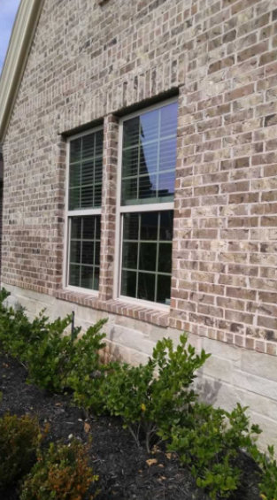 Newly installed black-framed windows in a bright residential living room