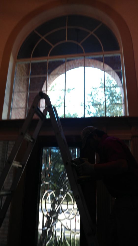 Installer working on decorative glass in an entry door