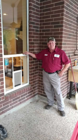 Bailey Glass Services technician beside a completed window installation